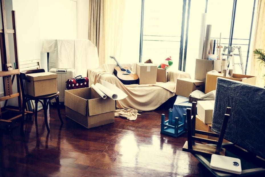 living room with boxes and items strewn about for packing and moving by The Moving Guys in Rapid City.