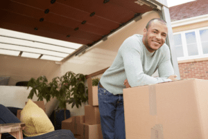 Man unloading moving boxes from truck
