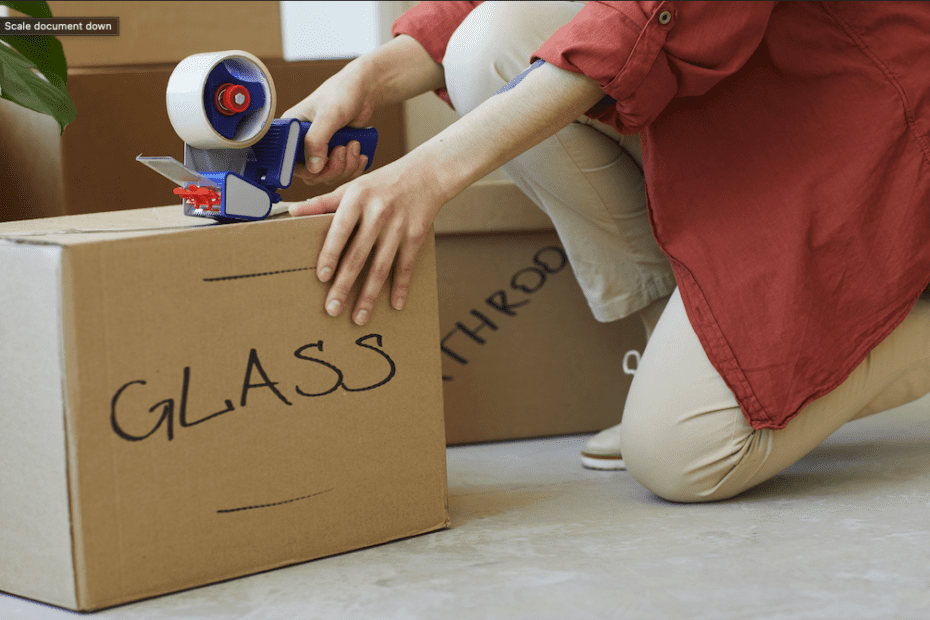 woman packing up glass items to move