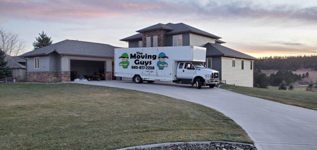 Moving Guys truck outside of house