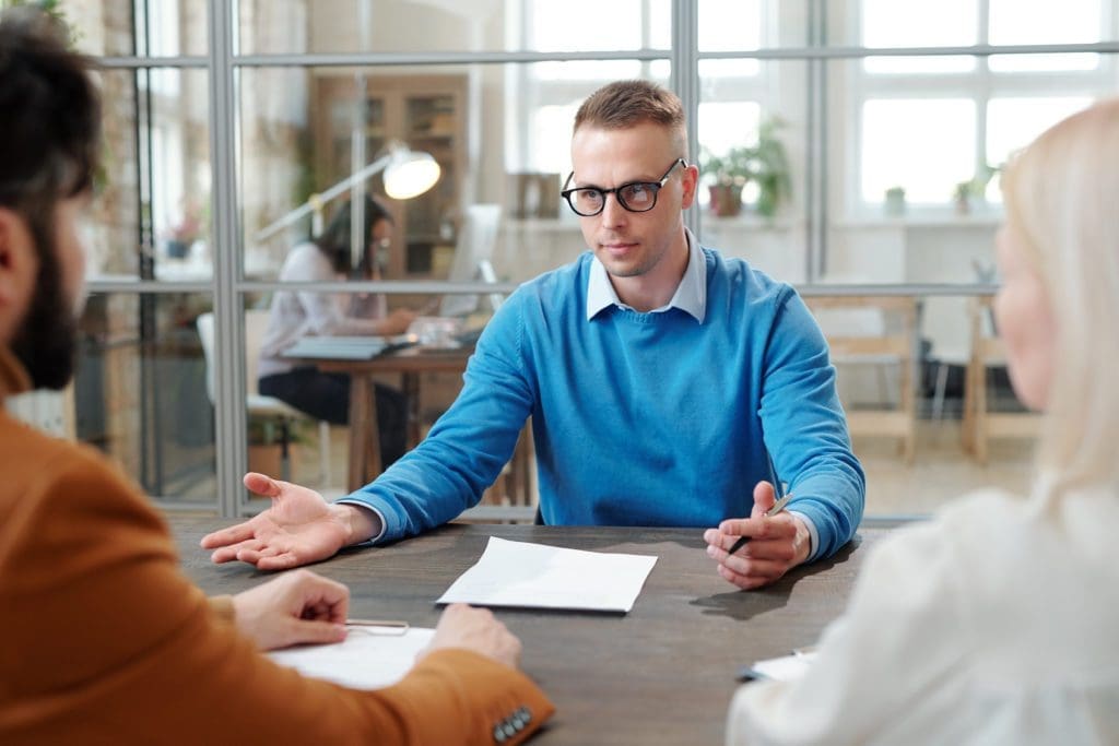 Employee talking over relocation, moving expenses and the plan with employer to move with The Moving Guys in Rapid City, SD.