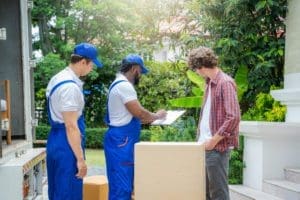 The Moving Guys in Blue overalls helping with Employee Relocation Services.